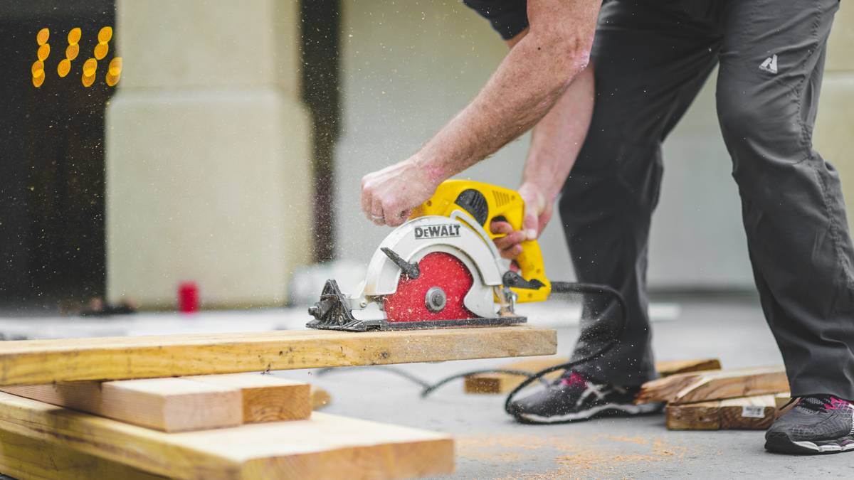 tools jig saw cutting a curved pattern in plywood on a workbench